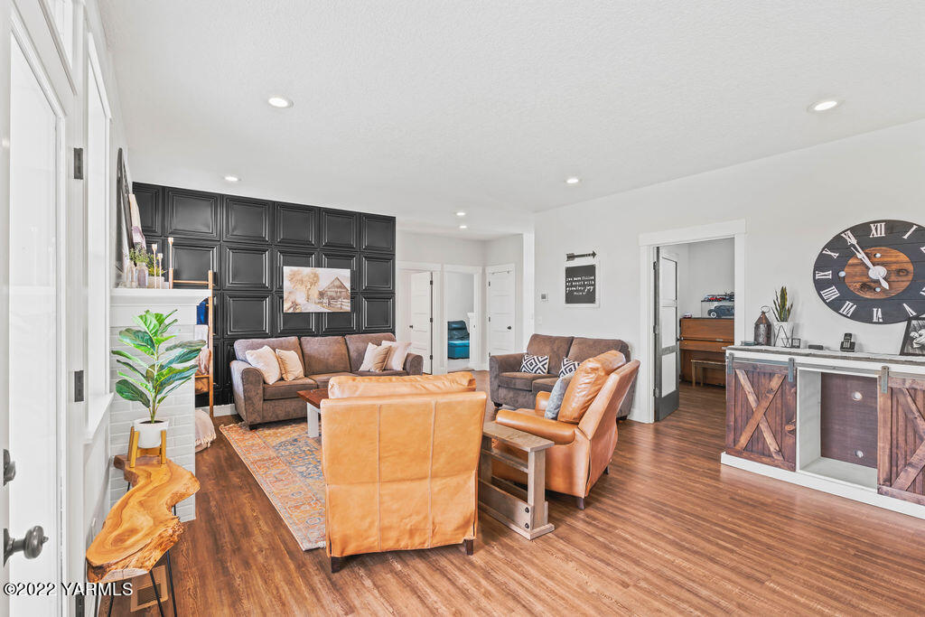 1058 East Road Bickleton, WA 99322 - Photo 21 of 39 a living room with furniture a wooden floor and a fireplace