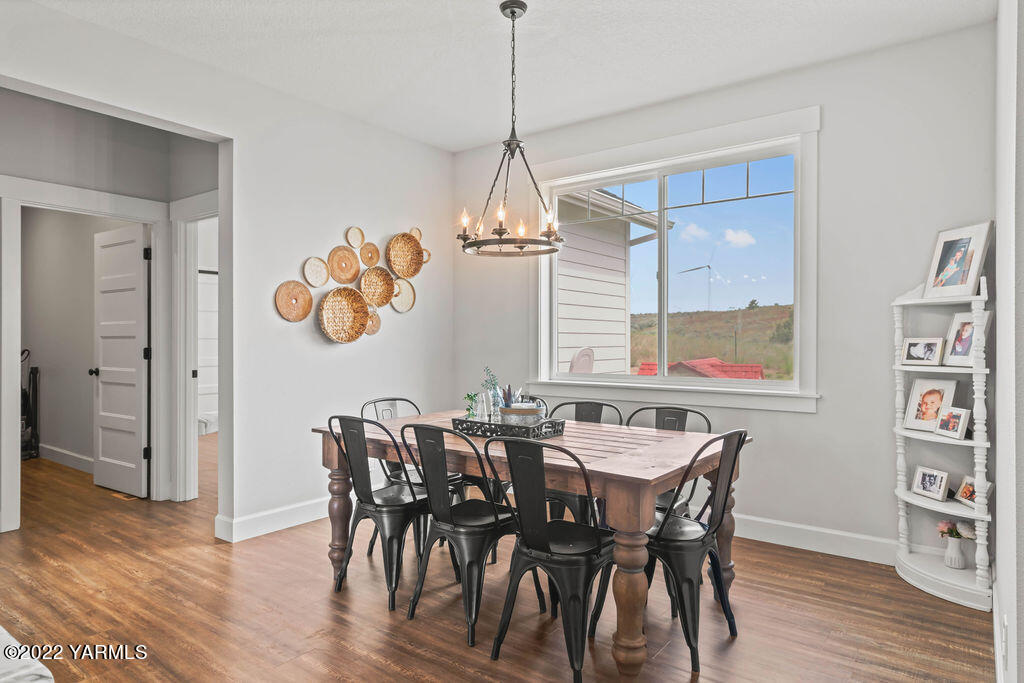 1058 East Road Bickleton, WA 99322 - Photo 22 of 39 a dining room with furniture a window and wooden floor