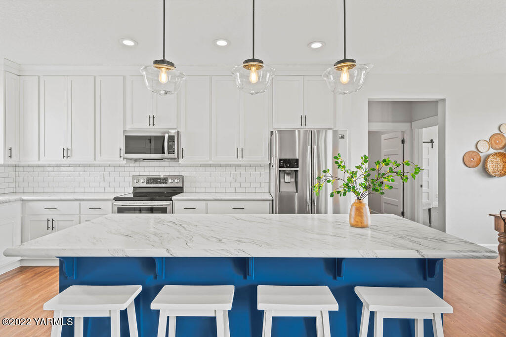 1058 East Road Bickleton, WA 99322 - Photo 23 of 39 a kitchen with a table chairs sink and cabinets