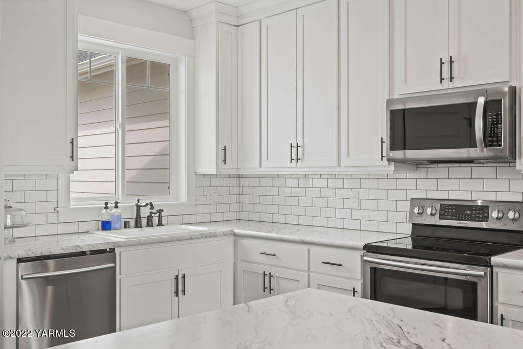 1058 East Road Bickleton, WA 99322 - Photo 24 of 39 a kitchen with cabinets stainless steel appliances and sink