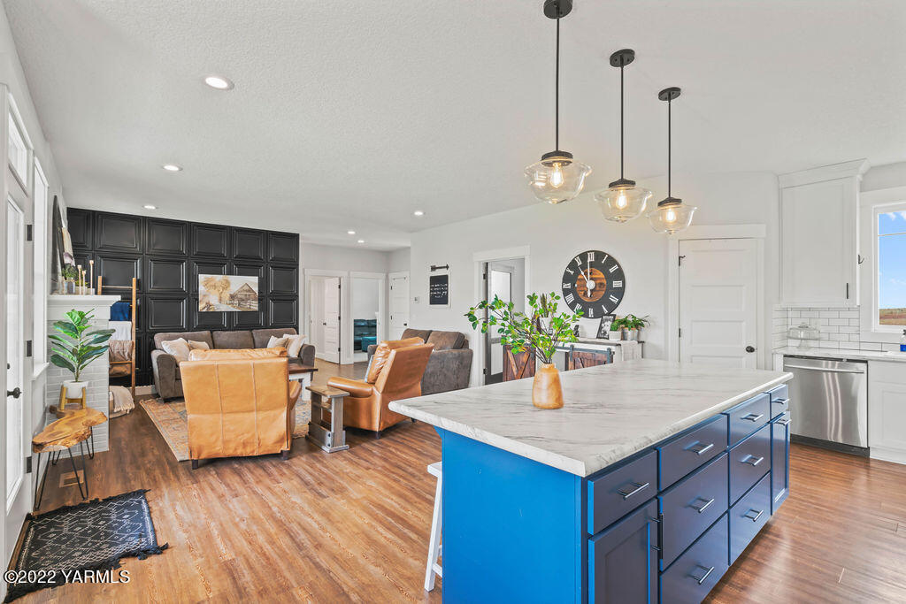 1058 East Road Bickleton, WA 99322 - Photo 28 of 39 a living room with kitchen island furniture and wooden floor