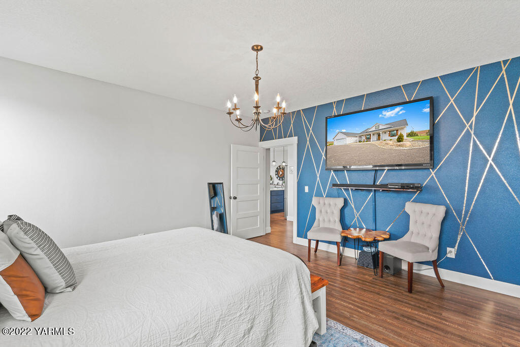 1058 East Road Bickleton, WA 99322 - Photo 33 of 39 a bedroom with a bed and a chandelier