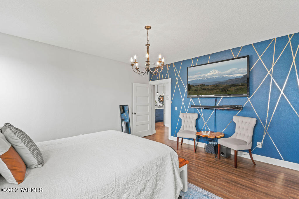 1058 East Road Bickleton, WA 99322 - Photo 34 of 39 a bedroom with a bed and a chandelier
