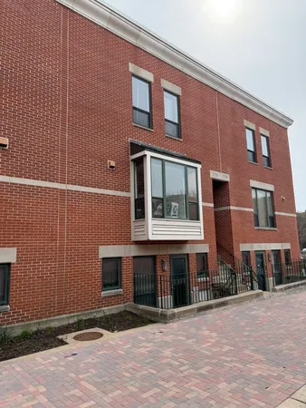 a front view of a building with a yard