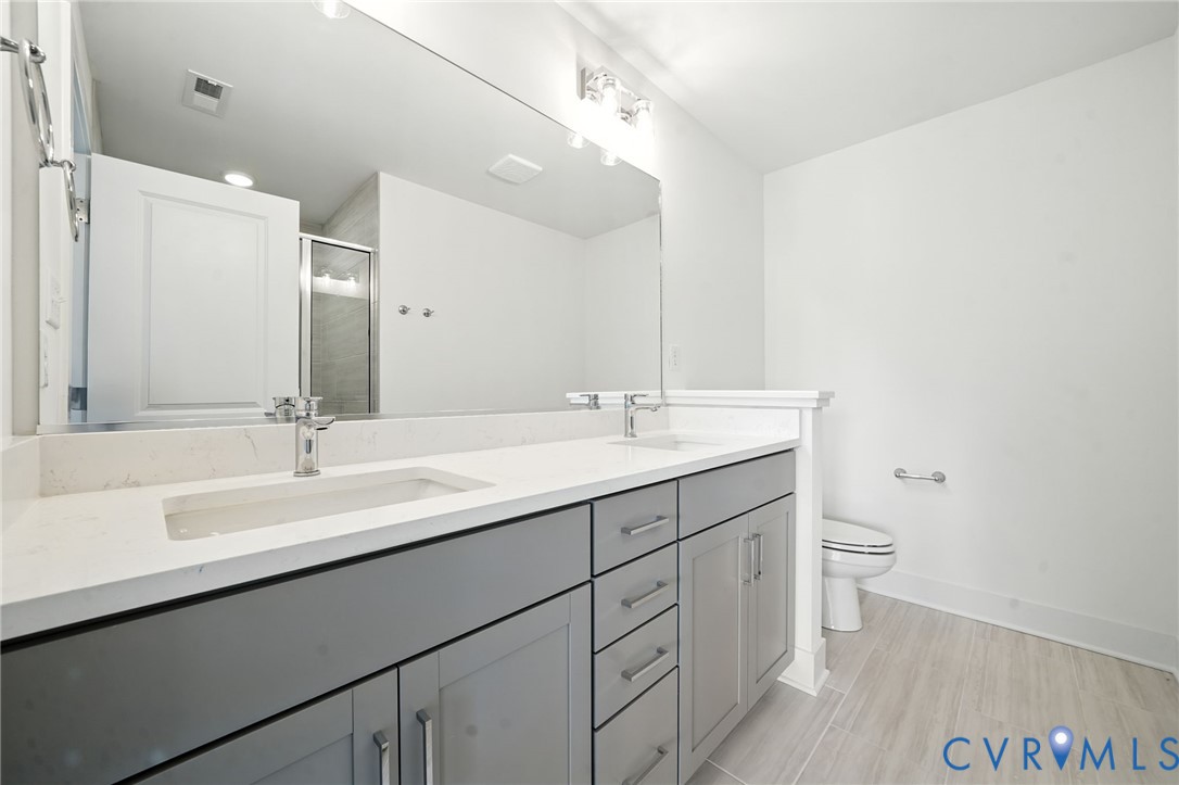 15307 Sunray Way Chesterfield, VA 23832 - Photo 13 of 27 a bathroom with a double vanity sink and a mirror