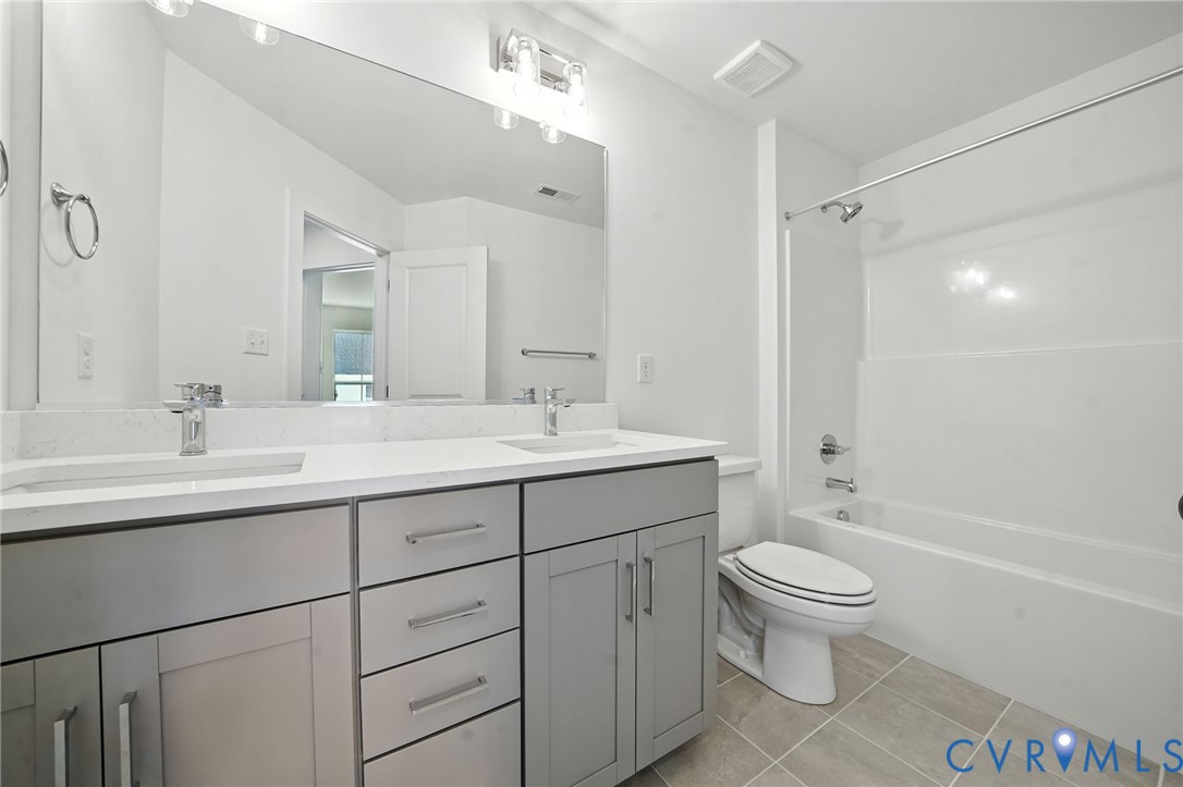 15307 Sunray Way Chesterfield, VA 23832 - Photo 17 of 27 a bathroom with a sink toilet double vanity and shower