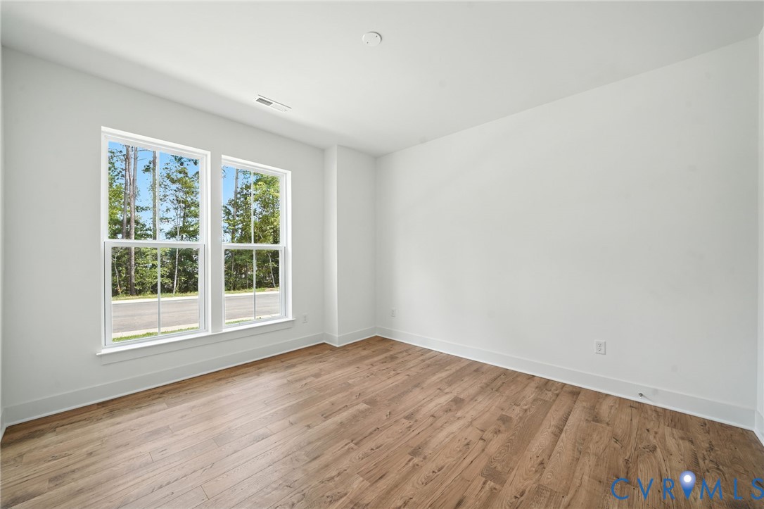 15307 Sunray Way Chesterfield, VA 23832 - Photo 7 of 27 an empty room with wooden floor and windows
