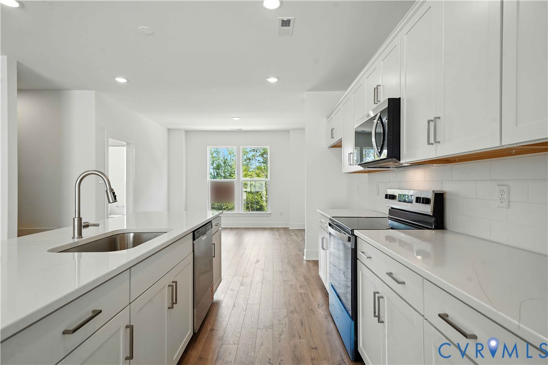 15307 Sunray Way Chesterfield, VA 23832 - Photo 9 of 27 a kitchen with sink a microwave and cabinets