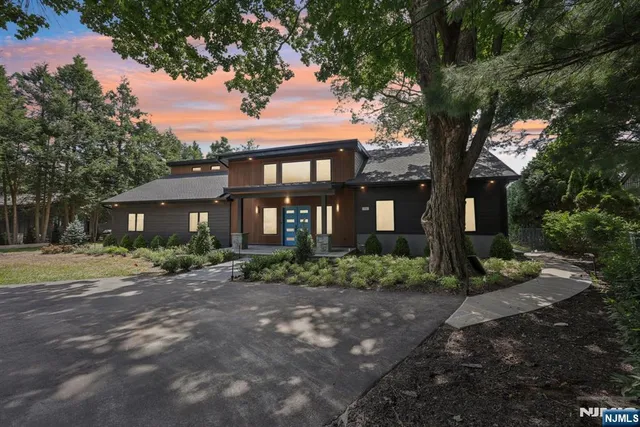 a front view of a house with a garden