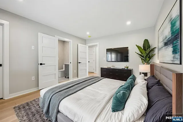 a bedroom with a large bed and a flat screen tv