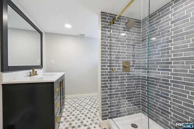 a bathroom with a sink a toilet and mirror