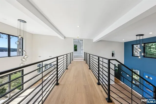 a view of staircase with lots of frames on wall and a window