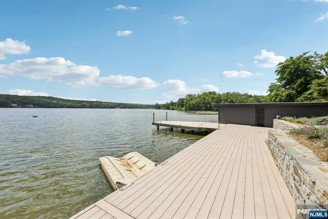 a view of a lake with wooden floor and city view