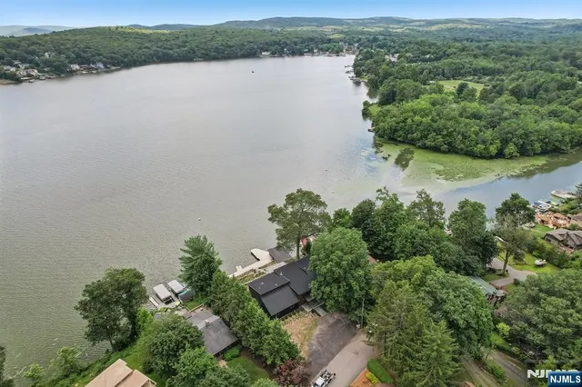 an aerial view of a houses with a lake view