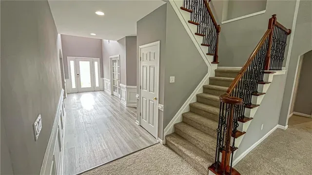 a dining room with furniture and wooden floor