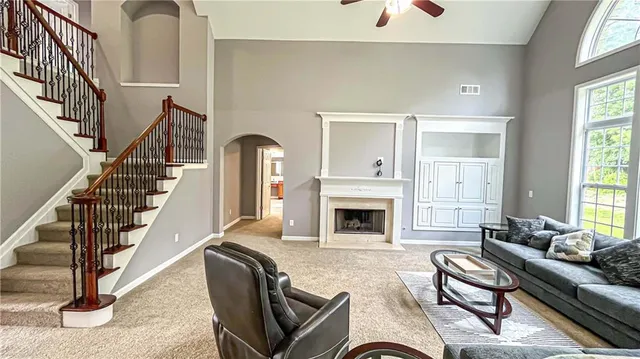 a kitchen with stainless steel appliances a stove a sink a counter space and a window