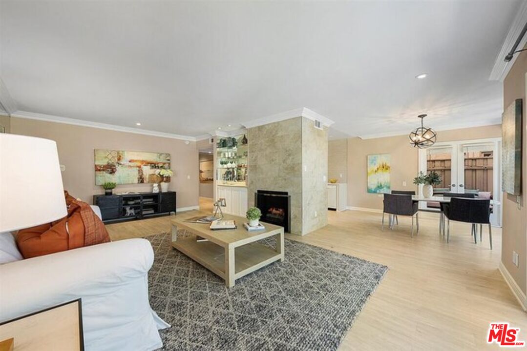 2345 Roscomare Road, Unit 201 Los Angeles, CA 90077 - Photo 4 of 18 a living room with furniture and a fireplace