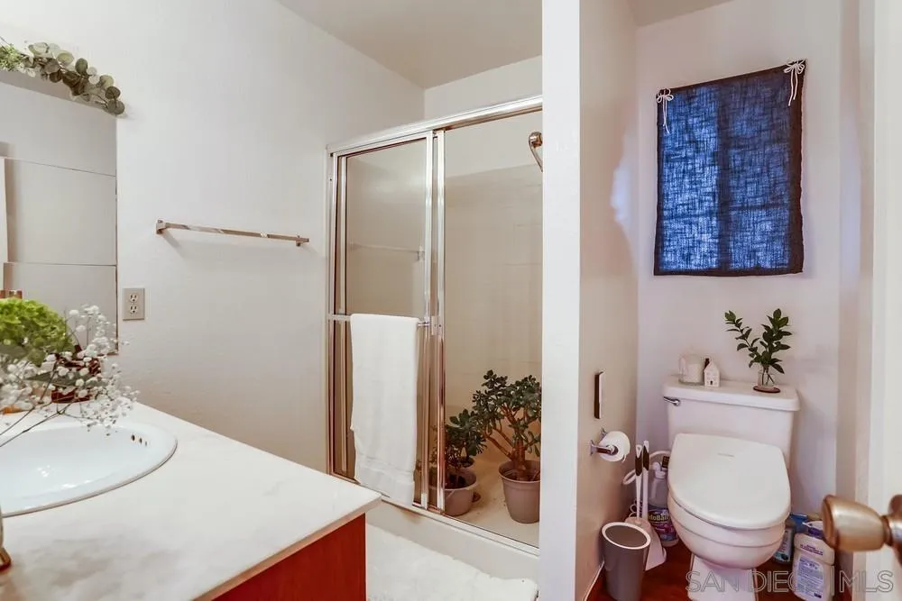 569 E Street, Unit 27 Chula Vista, CA 91910 - Photo 12 of 20 a bathroom with a sink toilet and shower