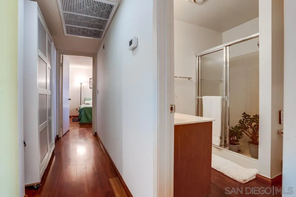 569 E Street, Unit 27 Chula Vista, CA 91910 - Photo 13 of 20 a view of a hallway with wooden floor and a bathroom
