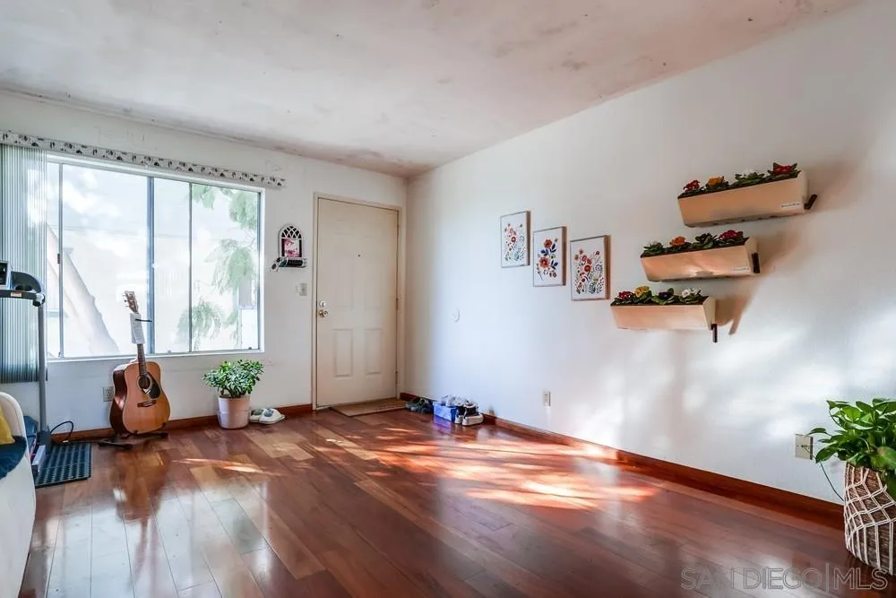 569 E Street, Unit 27 Chula Vista, CA 91910 - Photo 4 of 20 a view of empty room with floor to ceiling window and wooden floor