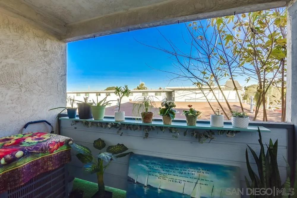 569 E Street, Unit 27 Chula Vista, CA 91910 - Photo 9 of 20 a dining room with furniture and a floor to ceiling window