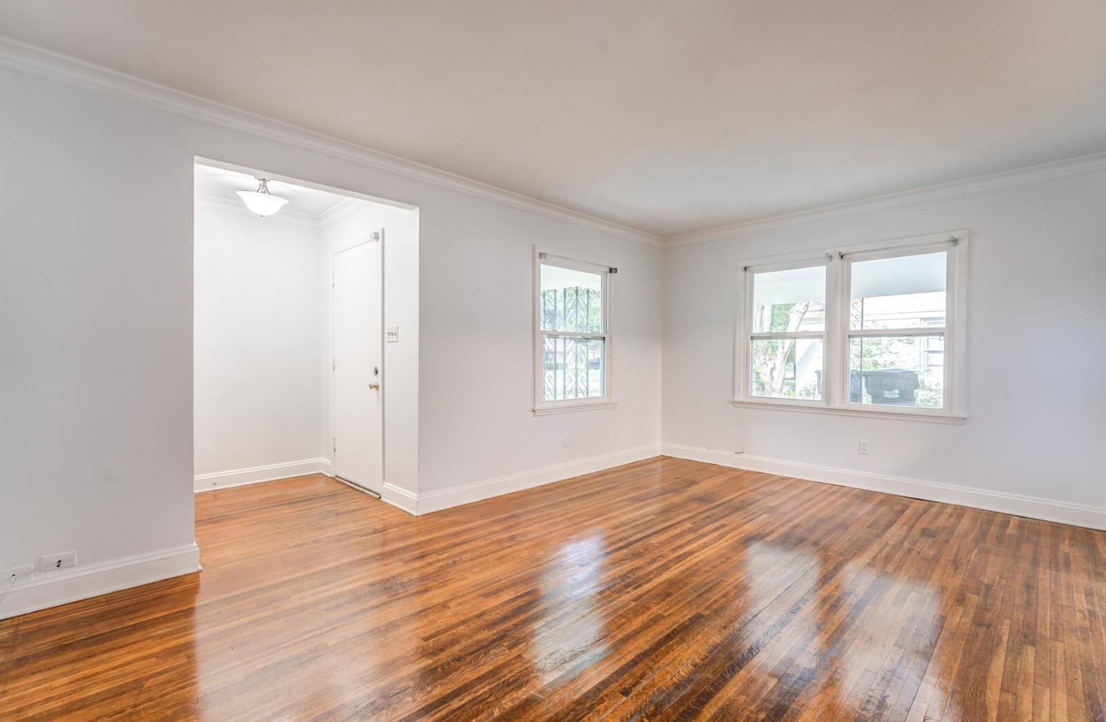 4613 Boyce Road Memphis, TN 38117 - Photo 8 of 35 an empty room with wooden floor and windows