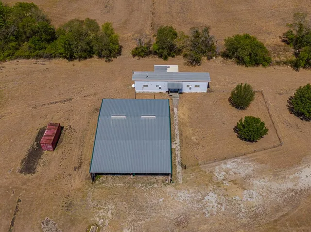 an aerial view of a house with a yard