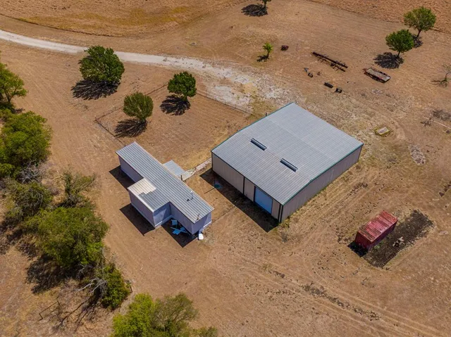 an aerial view of a house with a yard