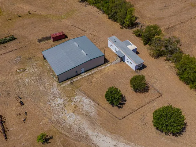 an aerial view of a house with a yard