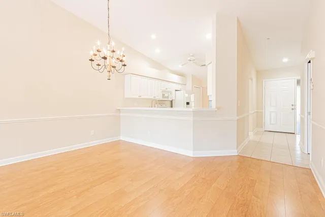 a view of a kitchen with kitchen island and stainless steel appliances