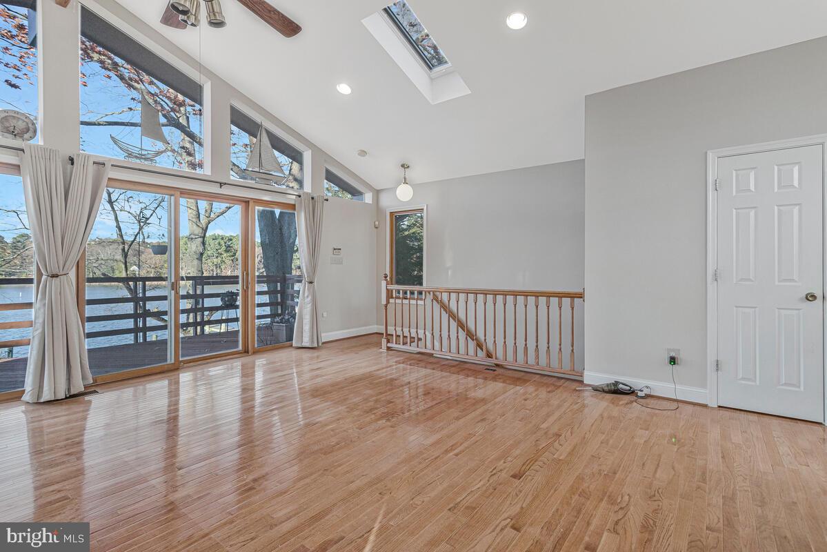 962 Main Street Deale, MD 20751 - Photo 13 of 54 an empty room with wooden floor and windows