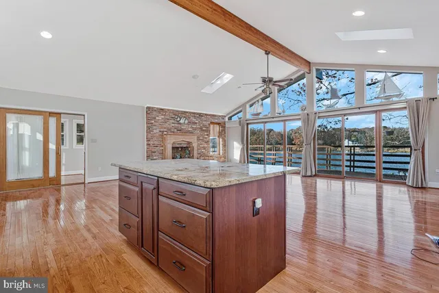 a kitchen with granite countertop a stove and wooden floor