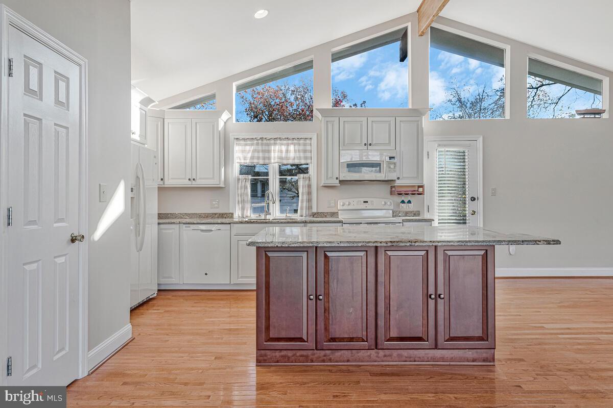 962 Main Street Deale, MD 20751 - Photo 20 of 54 a kitchen with stainless steel appliances granite countertop a stove a sink and a refrigerator