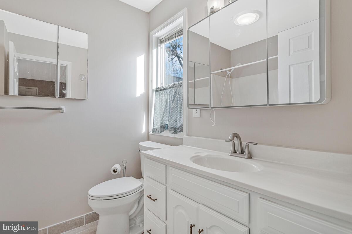 962 Main Street Deale, MD 20751 - Photo 27 of 54 a bathroom with a sink a toilet and mirror