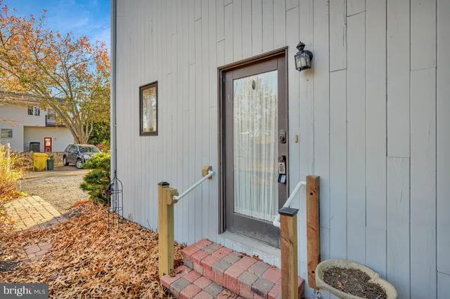 a view of a hallway with a furniture and entryway