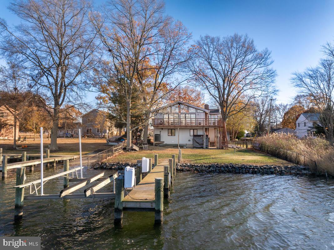 962 Main Street Deale, MD 20751 - Photo 46 of 54 a view of a swimming pool with sitting area and large trees