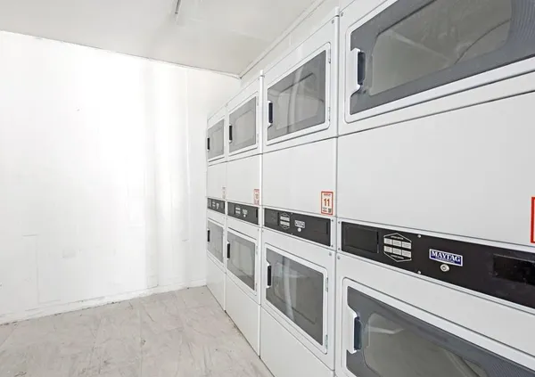 a view of a kitchen with white cabinets