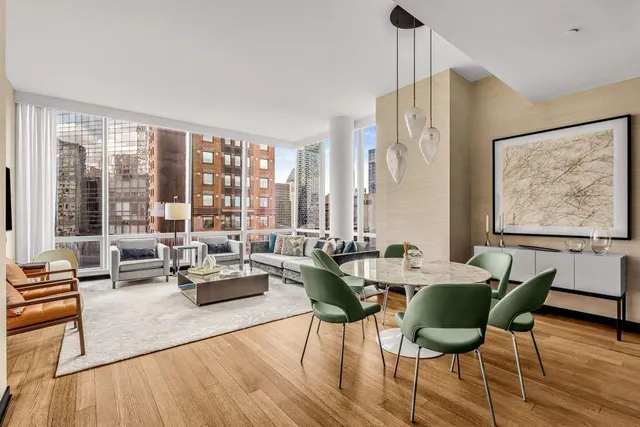 a living room with furniture and floor to ceiling windows