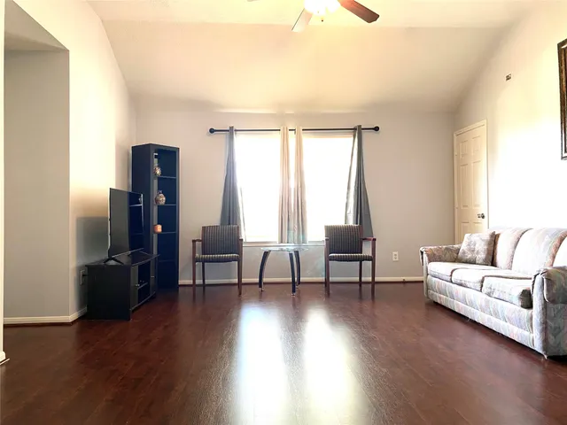 a living room with furniture and a large window