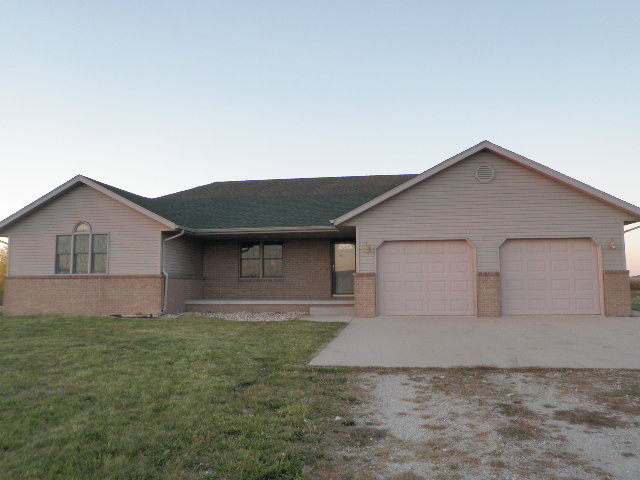 a front view of house with yard and trees