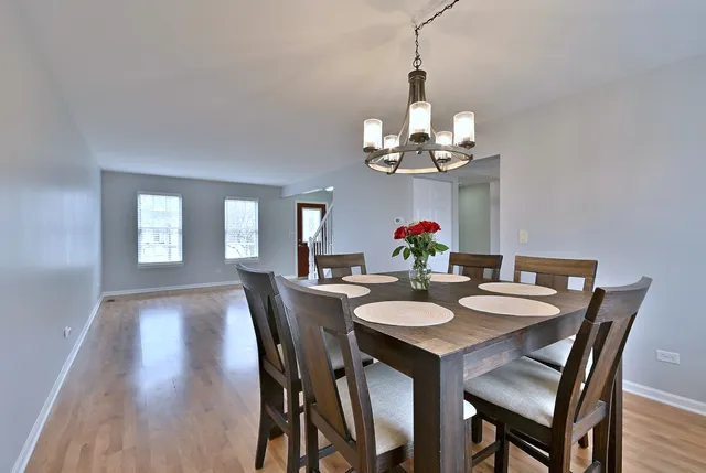 a view of a dining room with a table and chairs