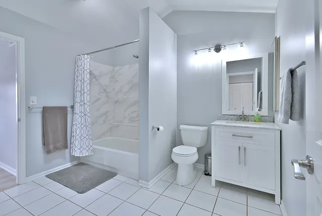a bathroom with a toilet a sink a mirror and a bathtub