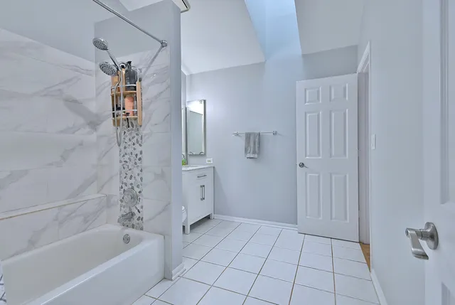 a bathroom with a bathtub and a shower