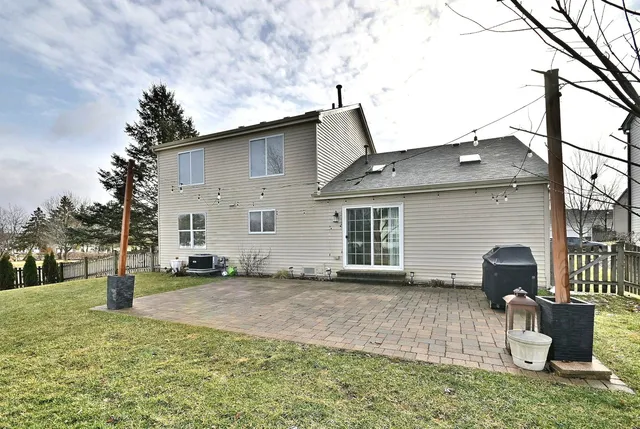 a backyard of a house with yard fire pit and outdoor seating
