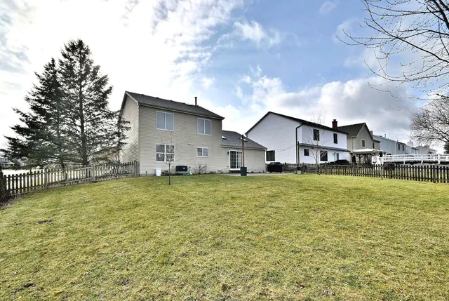 a house view with swimming pool in front of it