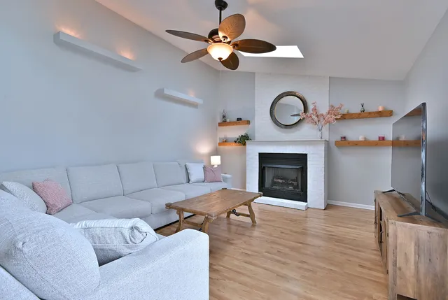 a living room with furniture a fireplace and a chandelier