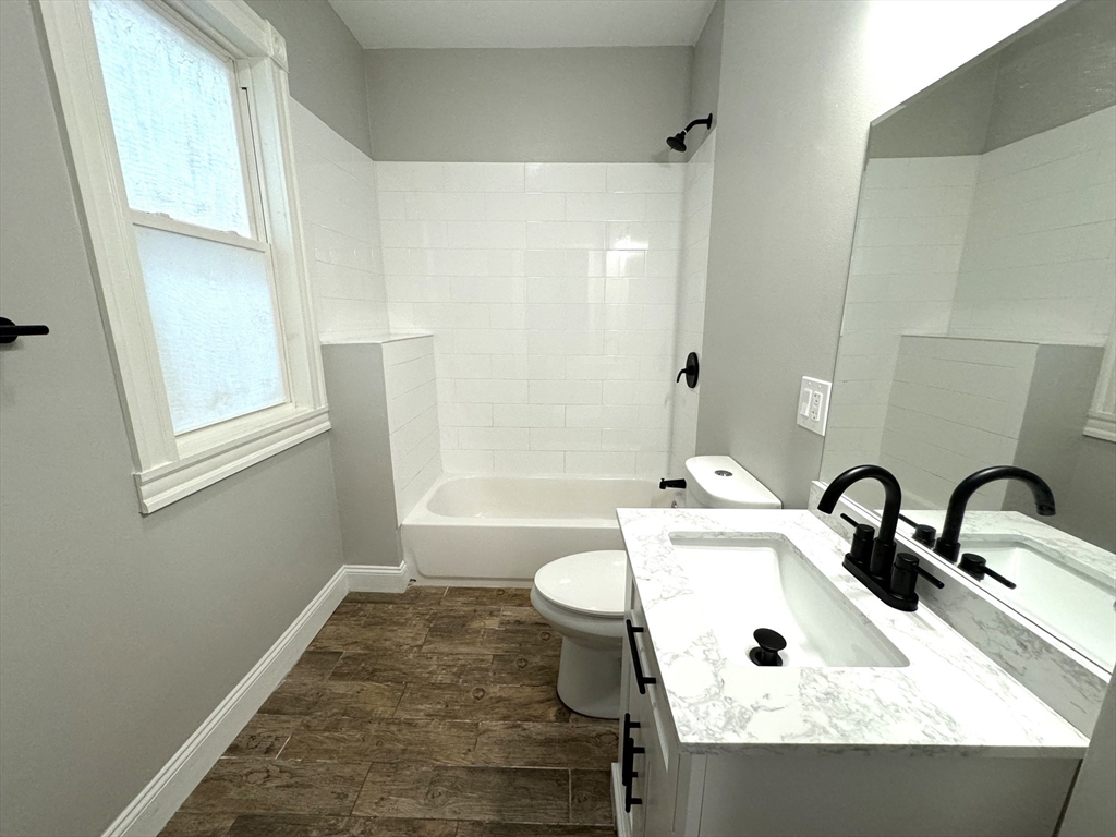 11 East Milton Road, Unit 1 Brookline, MA 02445 - Photo 20 of 24 a bathroom with a sink and a mirror