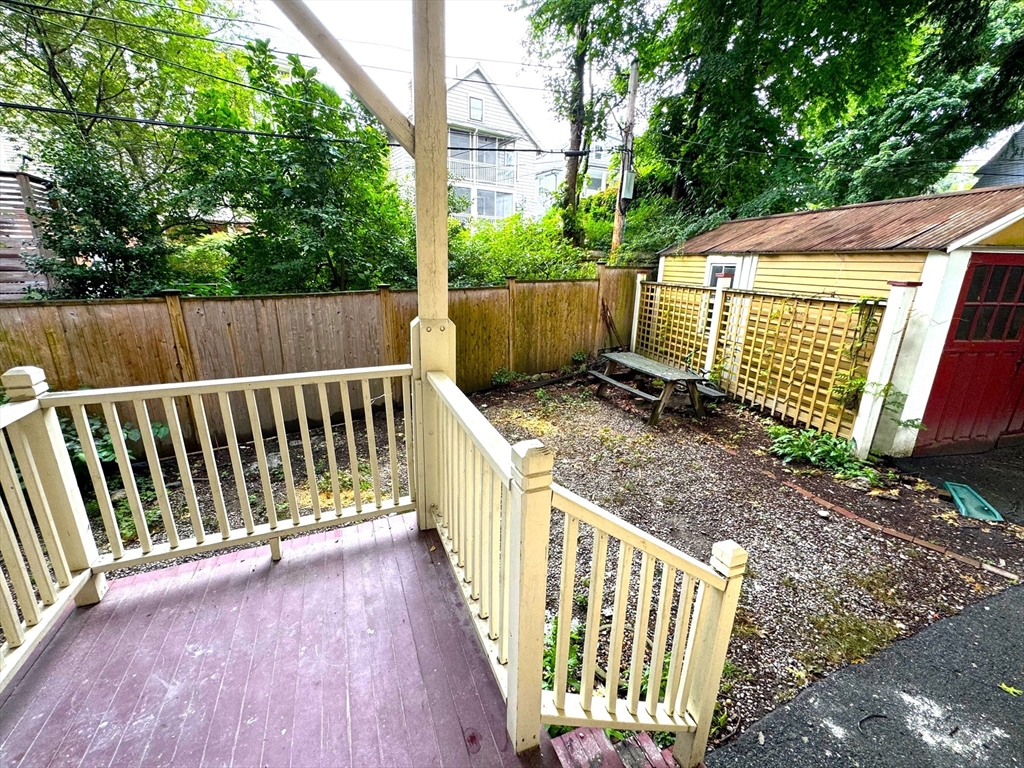 11 East Milton Road, Unit 1 Brookline, MA 02445 - Photo 22 of 24 a view of a small yard with wooden fence