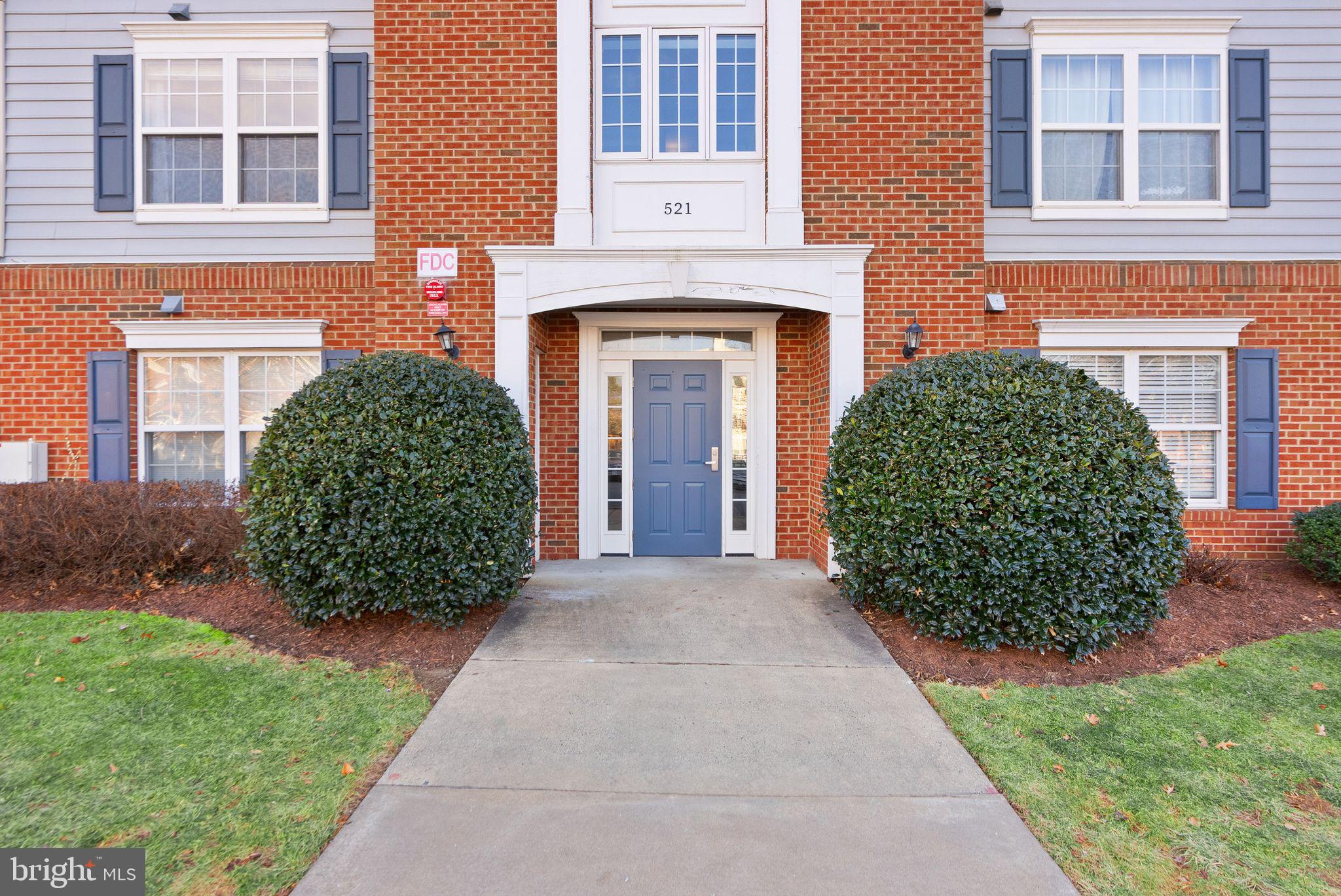 521 Constellation Square Southeast, Unit E Leesburg, VA 20175 - Photo 1 of 27 a front view of a house with a garden