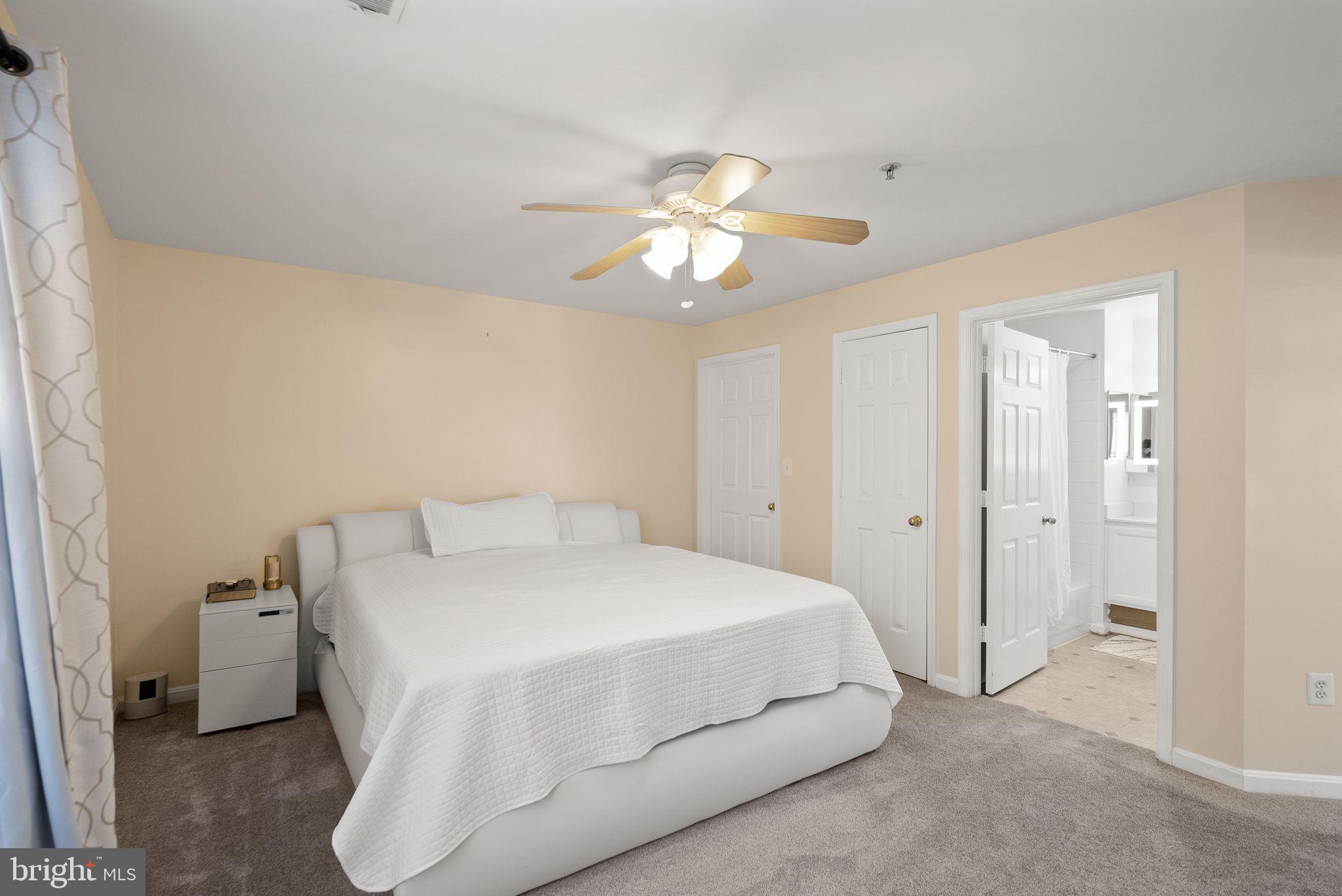 521 Constellation Square Southeast, Unit E Leesburg, VA 20175 - Photo 14 of 27 a bedroom with a bed and a chandelier